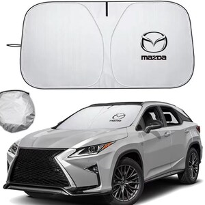May include: A silver car windscreen sun shade featuring the black Mazda logo and text. The shade is shown unfolded with a black border and folded into a circular storage pouch. The sun shade is also displayed installed on the windscreen of a silver SUV.