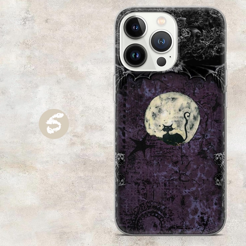 May include: A smartphone case featuring a dark purple, textured background with a large, pale, cratered moon and a black cat silhouette. The design includes intricate black filigree patterns, bat wings at the top, and a triple-lens camera cutout.