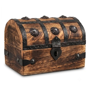 May include: A rectangular wooden chest with a domed lid, featuring dark brown wood grain and black metal bands. The chest is decorated with black metal studs and floral-shaped accents, and includes a central black metal latch with a keyhole.