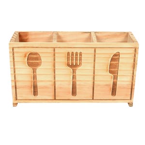 May include: A rectangular light brown wooden utensil holder featuring three distinct compartments. The front panel displays carved silhouettes of a spoon, a fork, and a knife, each centered within its own section, showcasing a natural wood grain finish.