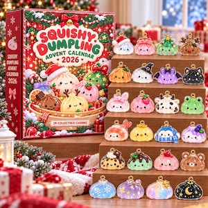 May include: A Squishy Dumpling Advent Calendar 2026 box featuring festive graphics and 24 collectible charms. The charms are arranged on a tiered wooden display, showcasing various colorful, small, character-themed dumpling designs with gold loops.