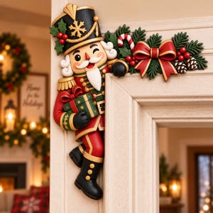 May include: A decorative nutcracker door corner accent featuring a soldier in a black, red, and gold uniform holding a green gift. The piece includes a red bow, pine branches, holly berries, and a candy cane, designed to mount on a door frame.