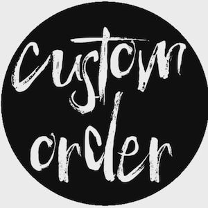 May include: A circular black graphic featuring the white text custom order written in a stylized, handwritten brush script font. The letters are textured and appear slightly distressed against the solid black circular background.