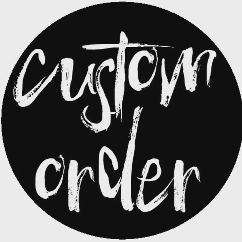 May include: A circular black graphic featuring the white text custom order written in a stylized, handwritten brush script font. The letters are textured and appear slightly distressed against the solid black circular background.