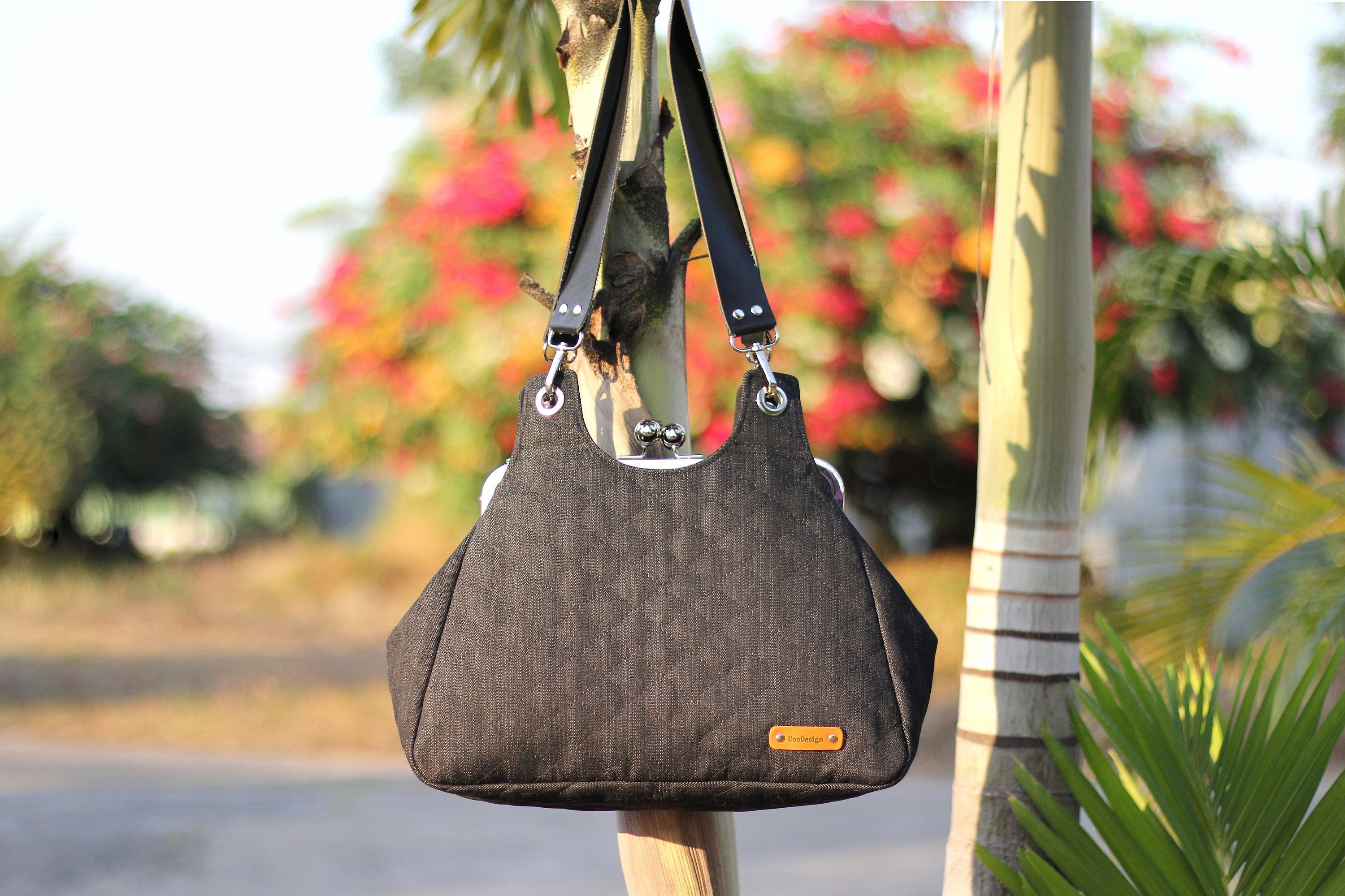 Denim Kiss Lock Shoulder Bag: Black Quilted Metal Frame