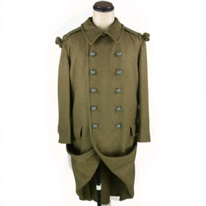 May include: An olive drab wool overcoat featuring a double-breasted front with ten round buttons, a wide collar, shoulder epaulets with decorative knots, and two large flap pockets at the hips, displayed on a mannequin torso.