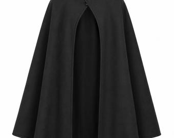 May include: A solid black cape featuring a high standing collar and a front closure with two visible buttons. The garment has a flared, open-front design that drapes downward, creating a structured silhouette with clean lines and a smooth texture.