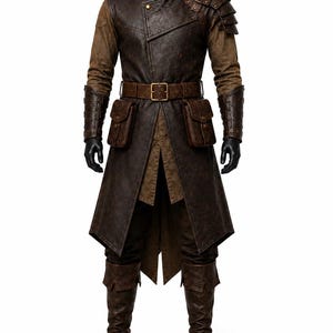 May include: A dark brown long coat with a high collar, layered over a brown shirt and trousers. The coat features a shoulder pauldron, a buckled waist belt with two attached pouches, forearm bracers, and knee-high boots in matching brown tones.