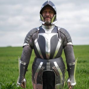 May include: A suit of armor featuring a dark matte finish with polished silver metal accents. The set includes a closed helmet, a breastplate, shoulder pauldrons, arm bracers, and chainmail sleeves, all secured with leather straps and metal buckles.