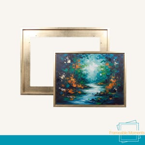 May include: An oil painting of a forest scene with a river, presented in a gold-coloured rectangular frame. The painting uses a vibrant palette of blues, greens, and oranges. The frame has a simple, elegant design.