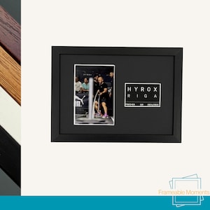 May include: Black picture frame with a photograph of a fitness competition and the text "HYROX RIGA FINISHER LVA 2024/2025". The frame is rectangular and has a matte finish.