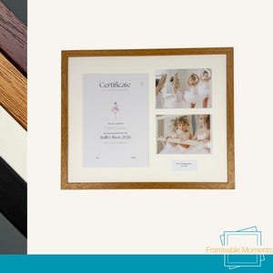 May include: A rectangular light wood picture frame containing a white mount with three apertures. The left side holds a Certificate of Achievement for a Ballet Show 2026. The right side features two photographs of young dancers in tutus.