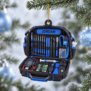 May include: A black and blue tool kit ornament featuring the name JORDAN printed in blue. The open case displays various precision screwdrivers, pry tools, tweezers, a digital USB tester, a small circuit board, a blower, and cables.