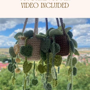 May include: Two crocheted hanging planters with trailing heart-shaped leaves in shades of green, light pink, and brown. The text BEGINNER CROCHET TUTORIAL | 35-MIN VIDEO INCLUDED is displayed at the top of the image in a brown serif font.