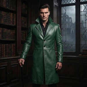 May include: A long, forest green leather coat featuring a structured collar, long sleeves, and a button-front closure. The coat is worn over a black collared shirt, creating a sleek, layered appearance with clean lines and a smooth, polished finish.