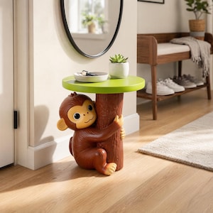 May include: A side table featuring a brown monkey figure hugging a textured brown tree trunk base that supports a round, lime green tabletop. A small white bowl containing keys and a small potted succulent plant sit on the green surface.