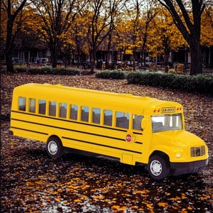 May include: A bright yellow school bus toy with black stripes and wheels. The bus has multiple windows and the words "SCHOOL BUS" are visible on the front. A red stop sign is on the side.