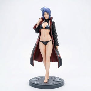 May include: A standing anime-style figurine of a character with short blue hair and a grey flower accessory. The figure wears a black bikini and an open black coat with a red interior lining, featuring red cloud patterns, mounted on a circular base.