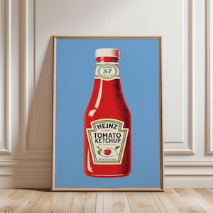 May include: A framed art print featuring a red Heinz Tomato Ketchup bottle centered on a solid light blue background. The label displays the text Heinz 57 Varieties, Tomato Ketchup, and Net Wt 14 oz (397g) with a small red tomato illustration.
