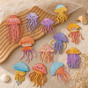 May include: A collection of eleven embroidered jellyfish patches in various colors including pink, purple, orange, yellow, and blue. Each jellyfish features a rounded bell top and multiple dangling tentacles, with some designs displaying small smiling faces.