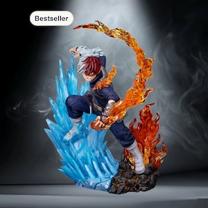 Op de afbeelding: Een dynamisch beeldje van een personage met rood en wit haar, gekleed in een donkerblauwe outfit, te midden van levendig blauw ijs en oranje vlammen. Het beeldje staat op een rotsachtige basis, met een "Bestseller" label.