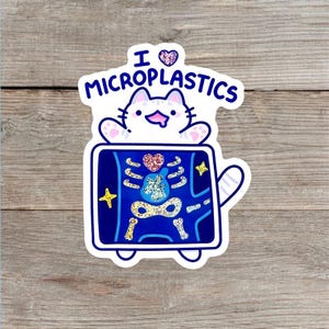 May include: A die-cut sticker featuring a white cartoon cat with a blue outline, holding an X-ray showing a glittery skeleton and heart. The text above reads I (heart symbol) MICROPLASTICS in dark blue, with a glittery purple heart icon.