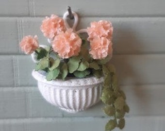 Wall flower pot with apricot geraniums