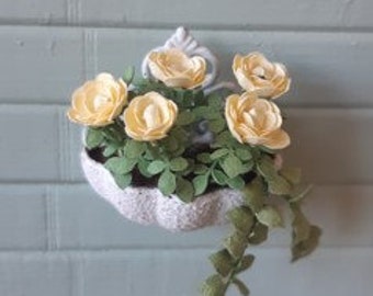 Wall flower pot with yellow roses