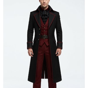 May include: A long black coat with dark red piping, worn over a deep red vest and matching trousers. The ensemble includes a black ruffled cravat and a dark belt with a buckle, featuring a structured collar and long sleeves with wide cuffs.