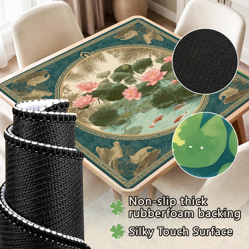 May include: A square table mat with a teal and beige floral design featuring pink lotus flowers, lily pads, and koi fish. The mat has a non-slip rubberfoam backing and a silky touch surface. A rolled-up black mat with white trim is in the foreground.