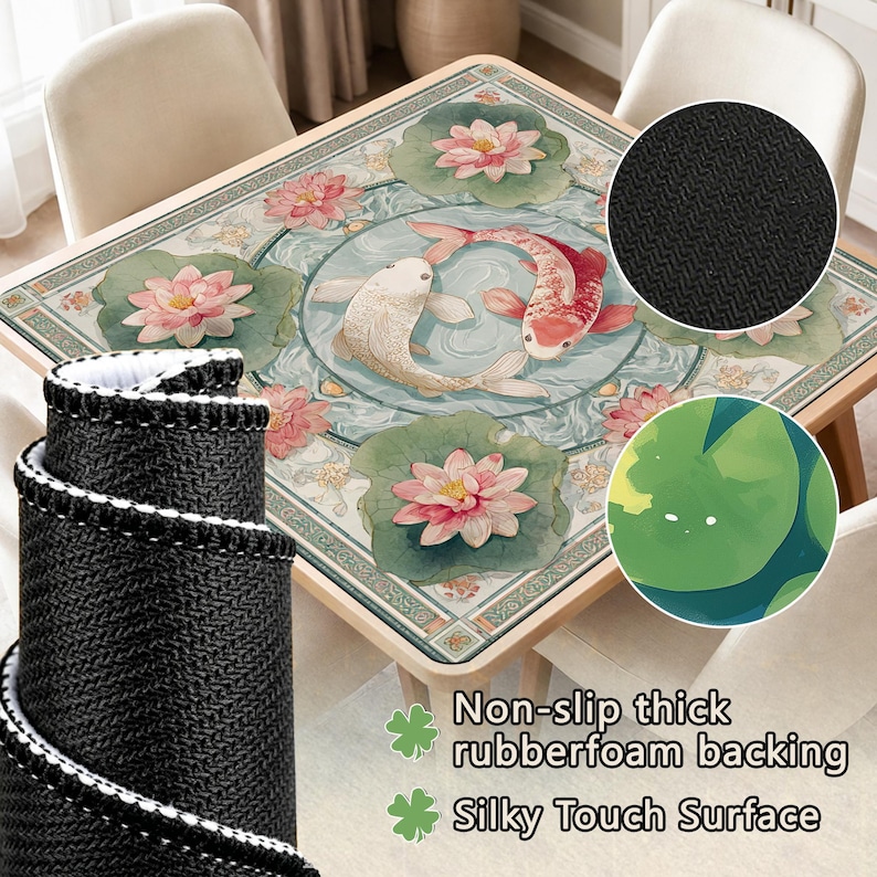 May include: A square table mat featuring a central circular design of two koi fish swimming in water, surrounded by pink lotus flowers and green lily pads. The mat has a black textured non-slip rubber foam backing and a smooth silky top surface.