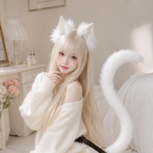 May include: A set of white faux fur cat ears on a headband and a long, matching white faux fur tail attached to a black adjustable belt. The ears feature soft white fur and pointed tips, while the tail is curved and fluffy in texture.