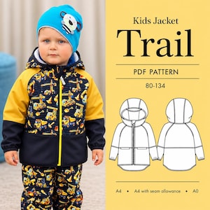 May include: A child wearing a blue beanie with a bear design and a matching jacket and pants set. The jacket has yellow sleeves and a navy blue body with a construction vehicle pattern. The text "Kids Jacket Trail" is visible.