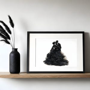May include: A black framed print featuring an illustration of two skeletons embracing, one wearing a voluminous black gown with floral details and the other in a black suit. Beside the frame stands a black vase containing black dried grass.