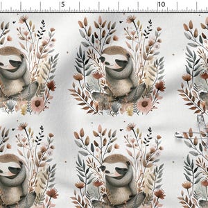 May include: Fabric featuring a repeating pattern of watercolor sloths surrounded by floral and botanical elements. The sloths are depicted in shades of gray and brown, with the flowers in muted pinks and browns. The background is a soft white.