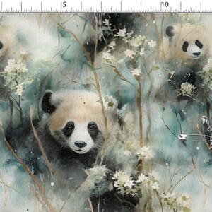 May include: A fabric print featuring a watercolour-style pattern of giant pandas surrounded by thin branches and small white flowers in shades of teal, green, and cream. A metal safety pin is attached to the right side of the fabric.