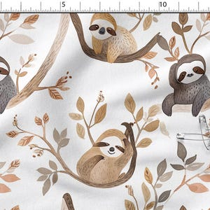 May include: A white fabric with a repeating pattern of sloths in various poses, perched on brown tree branches with tan and brown leaves. The sloths are depicted in shades of gray and brown, creating a whimsical, nature-themed design.