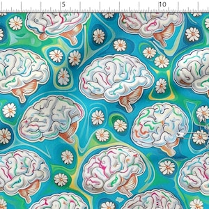 Può includere: Una stampa su tessuto con un motivo ripetuto di cervelli anatomici in tonalità di bianco e grigio con accenti colorati, intervallati da piccole margherite bianche su uno sfondo blu e verde vorticoso, mostrato con un righello.