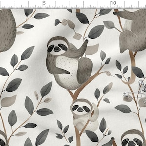 May include: Fabric with a repeating pattern of sloths in a tree. The sloths are in shades of gray and brown, with black eyes and a white belly. The leaves are gray, and the branches are brown. The background is white.