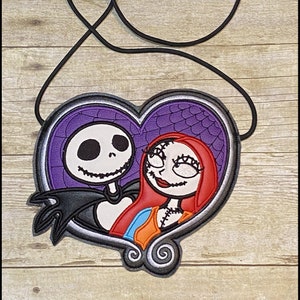 May include: A heart-shaped lanyard featuring Jack Skellington and Sally from The Nightmare Before Christmas. The design has a purple background with a spiderweb pattern, and a black cord. The text "K's Kreations" is at the top.