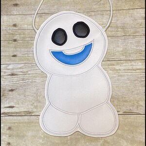 May include: A white crossbody bag shaped like a smiling snowman with black eyes and a blue mouth. The bag has a white cord strap and the text "K's Kreations" at the bottom.
