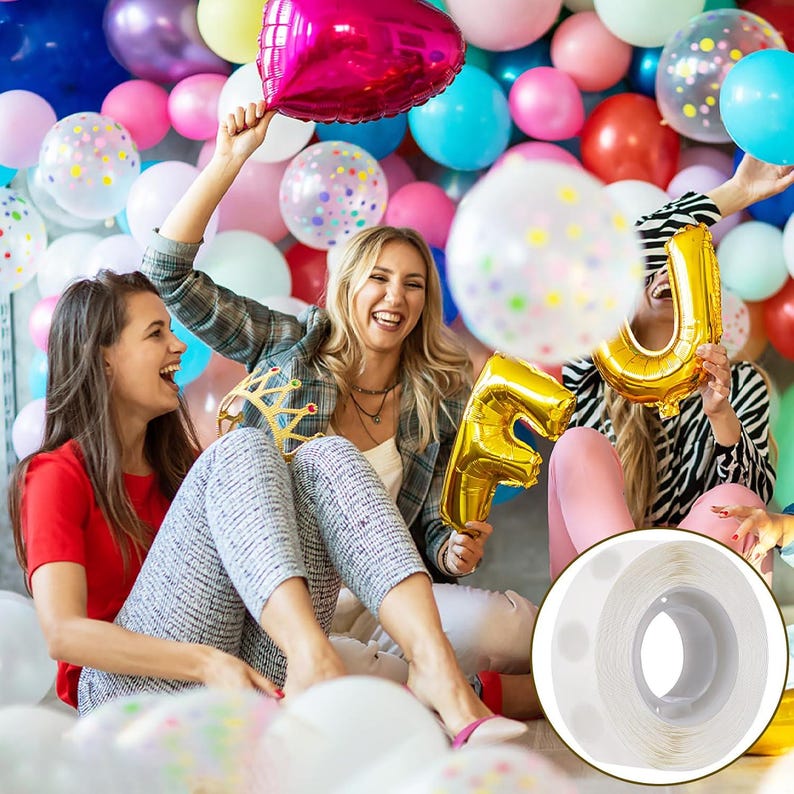 May include: A roll of clear, double-sided adhesive balloon glue dots on a white plastic spool, designed for attaching balloons together or to surfaces, shown as a circular inset against a background of people with colorful balloons.