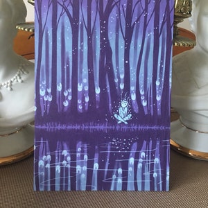 May include: A watercolor painting of a forest scene with a small, white, glowing figure sitting in the middle of a lake. The trees are dark purple and the water is a lighter shade of purple. The sky is a light blue with white dots.