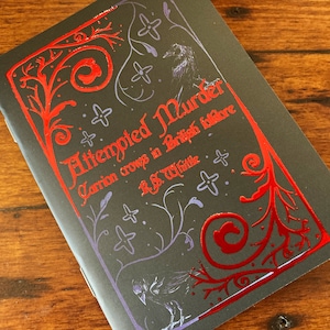 May include: A black book cover with a red and purple design. The title of the book is "Attempted Murder: Carrion Crows in British Folklore" by R.S. Whittle.