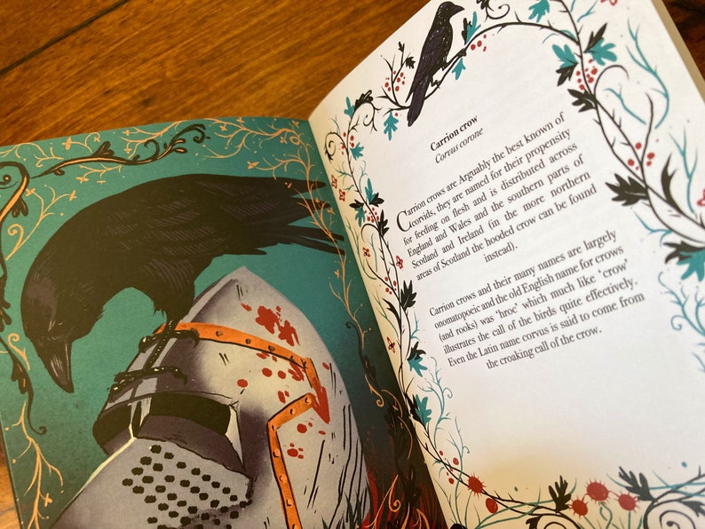 May include: A black crow perched on a medieval helmet with red blood splatters. The crow is depicted in a detailed illustration with a teal background and ornate floral borders. The text "Carrion crow" and "Corvus corone" is visible in the image.