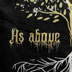 May include: A black canvas tote bag with a gold tree design and the words "As above" in gold lettering.