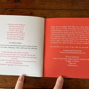 May include: Open book with red and white text on a white background. The left page has a poem about robins and the right page has information about the author and their other books. The text on the right page includes the title "Previous bird books" and the names of other books by the author.