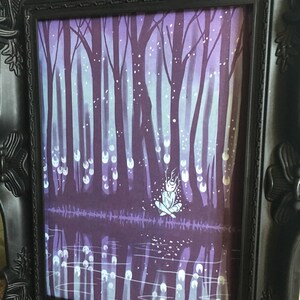 May include: A framed illustration of a figure sitting in a forest with a purple and blue color scheme. The figure is surrounded by glowing orbs and the forest is reflected in a body of water.