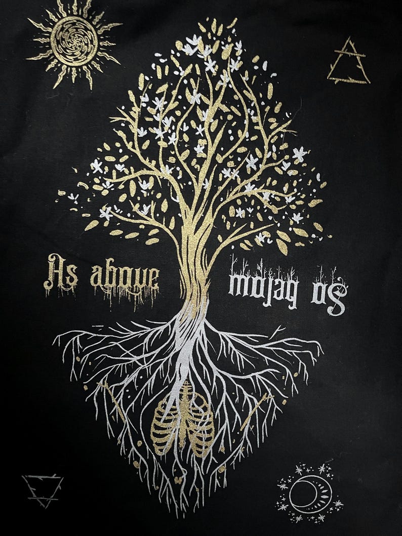 May include: A black background with a gold tree with white flowers and roots. The tree has a gold sun above it and a gold triangle above the tree. The roots are white and have a gold ribcage in the center. The text "As above so below" is written in gold on the left side of the tree and the text "So below as above" is written in gold on the right side of the tree.