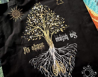 May include: Black tote bag with a gold tree design and the text "As above so below" and "maya us".